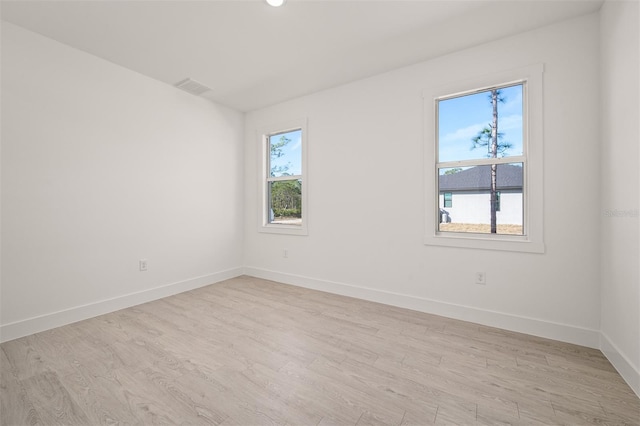 unfurnished room featuring light hardwood / wood-style floors