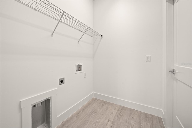 laundry area with electric dryer hookup, washer hookup, and light hardwood / wood-style floors