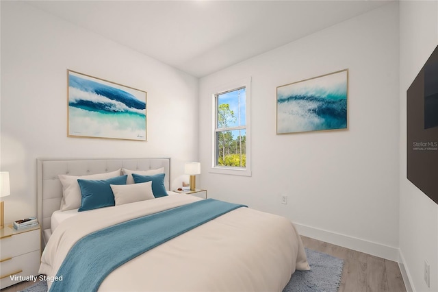 bedroom with hardwood / wood-style flooring