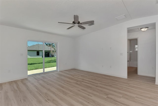 empty room featuring ceiling fan and light hardwood / wood-style flooring