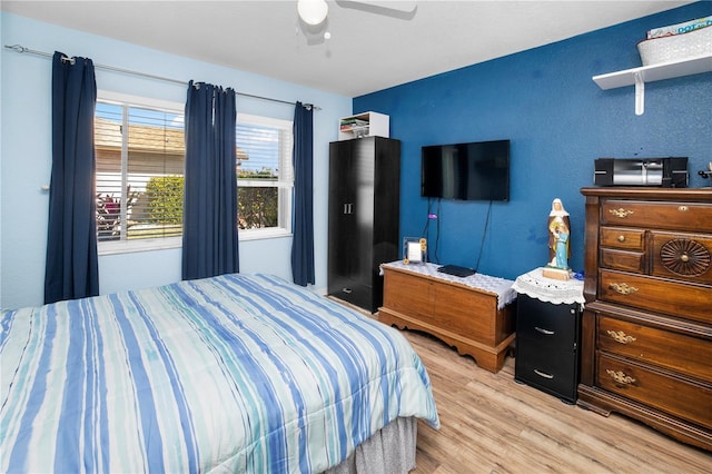 bedroom with ceiling fan and light hardwood / wood-style floors