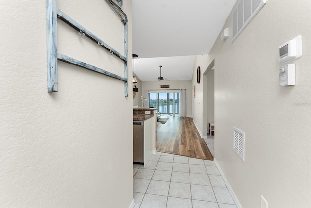 hallway featuring light tile patterned floors