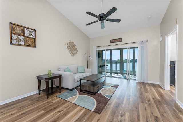 living room featuring hardwood / wood-style flooring, high vaulted ceiling, and ceiling fan