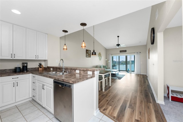 kitchen featuring sink, dishwasher, white cabinetry, hanging light fixtures, and kitchen peninsula