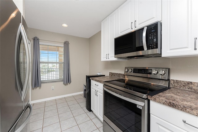 kitchen featuring white cabinetry, appliances with stainless steel finishes, and light tile patterned floors