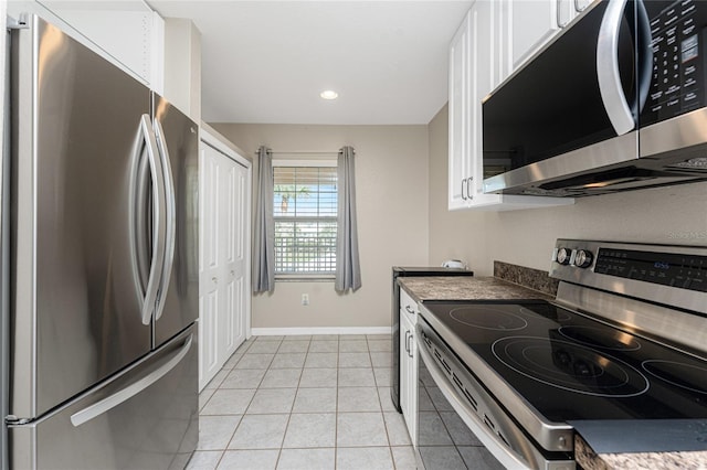 kitchen with white cabinetry, stainless steel appliances, and light tile patterned floors