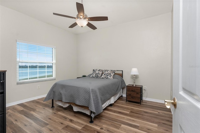 bedroom featuring dark hardwood / wood-style floors and ceiling fan