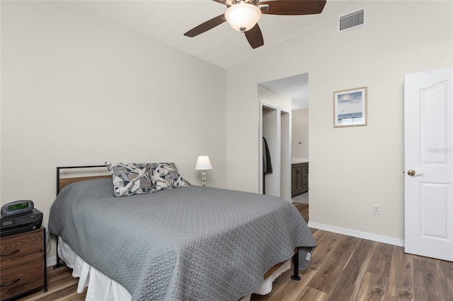 bedroom featuring dark wood-type flooring, ceiling fan, lofted ceiling, and connected bathroom