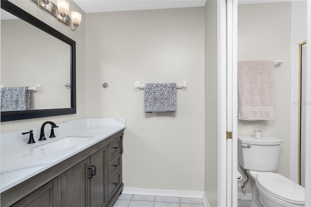 bathroom with vanity, tile patterned floors, and toilet