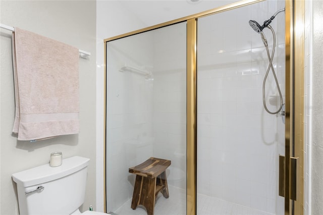 bathroom with a shower with door and toilet