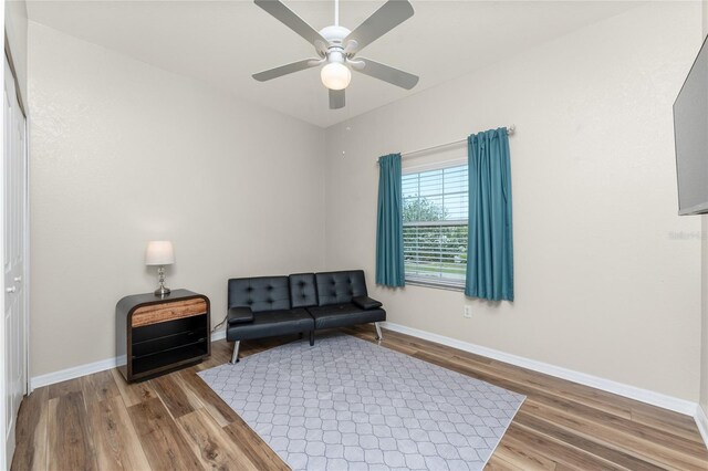 sitting room featuring ceiling fan and hardwood / wood-style floors