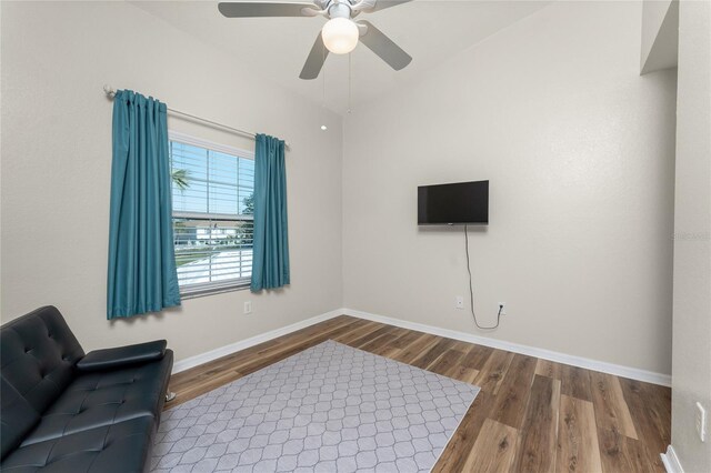 sitting room with hardwood / wood-style floors and ceiling fan