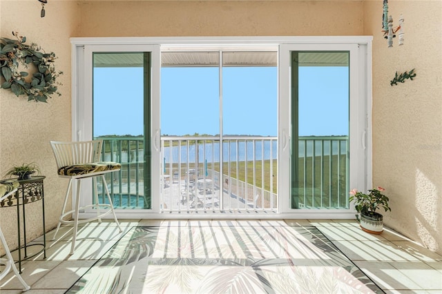 unfurnished sunroom with a water view