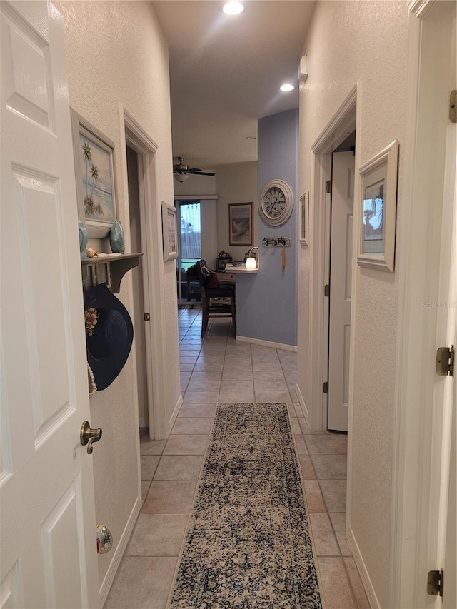 corridor featuring light tile patterned flooring