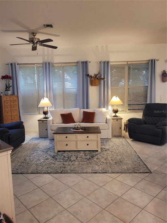 tiled living room with ceiling fan