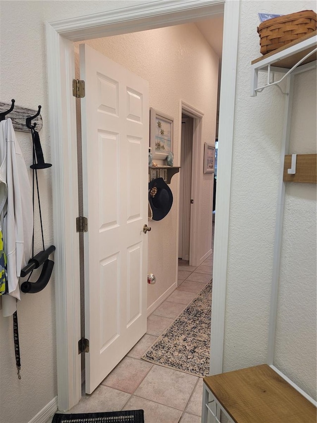 corridor with light tile patterned floors