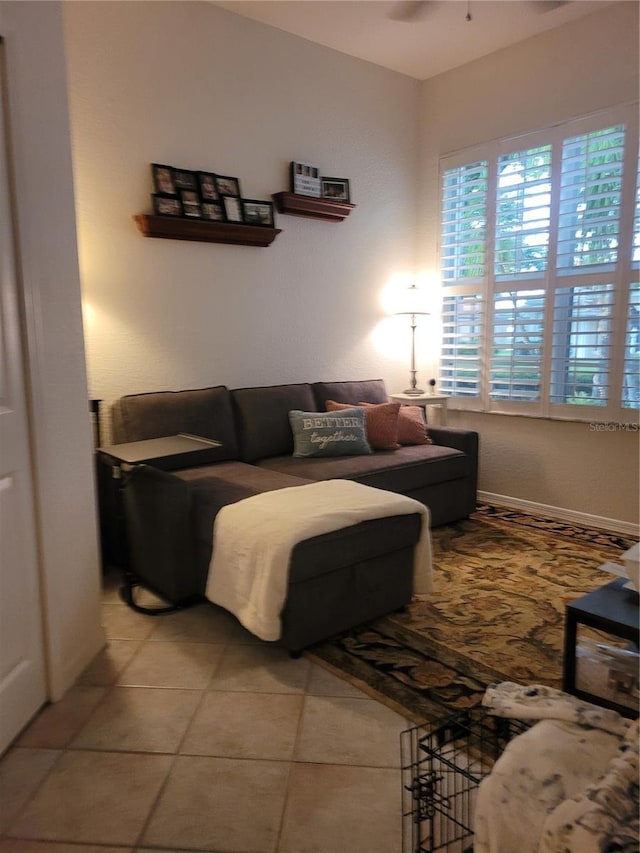 living room featuring ceiling fan and light tile patterned floors