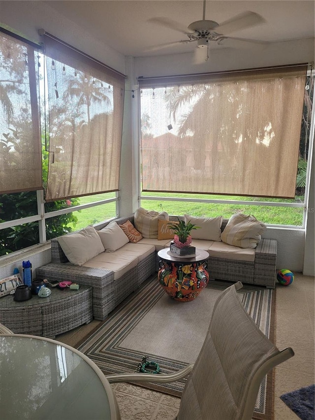 sunroom / solarium with a healthy amount of sunlight and ceiling fan