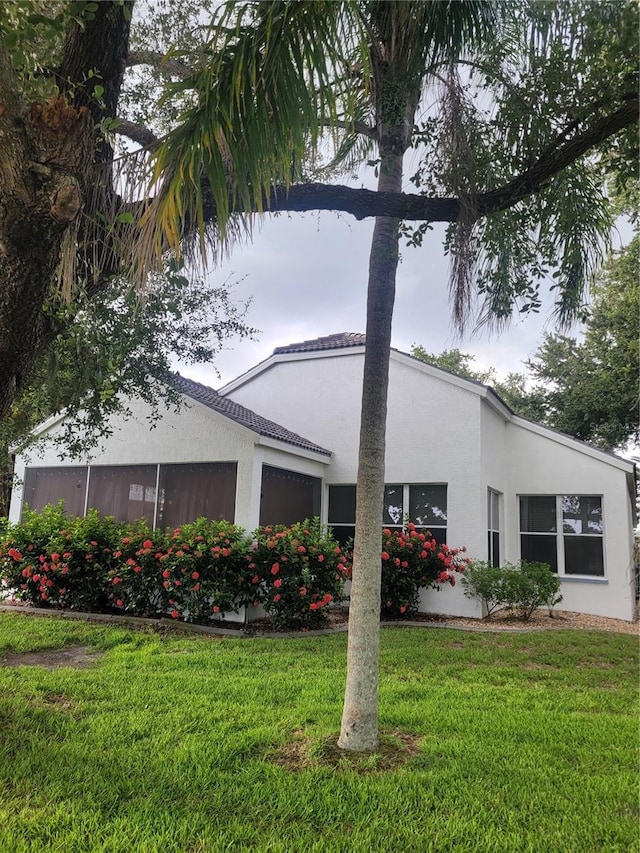 view of side of property with a lawn