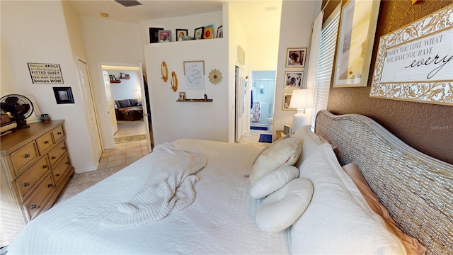 tiled bedroom featuring ensuite bath