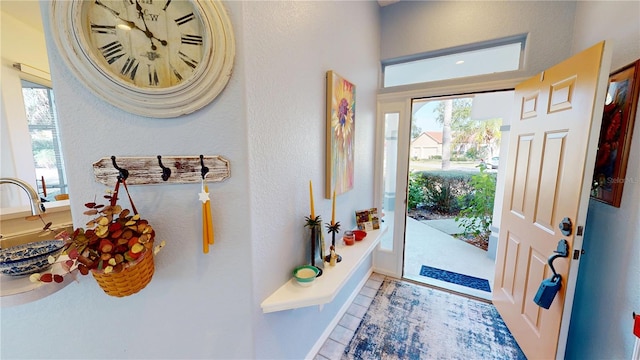 foyer entrance featuring plenty of natural light and tile patterned floors