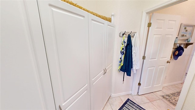 hallway featuring light tile patterned floors