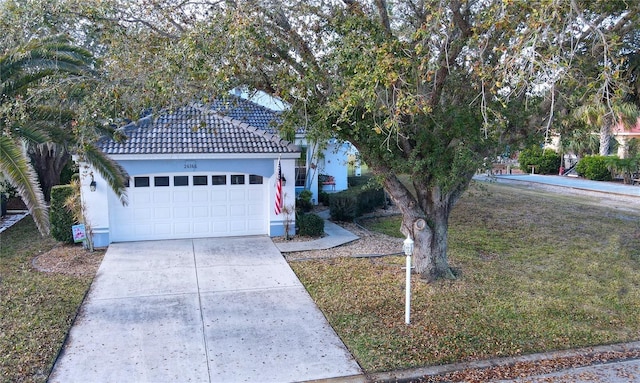 view of front of home with a garage and a front lawn