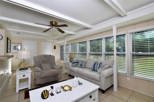 tiled living room with beamed ceiling and ceiling fan