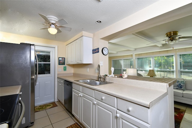 kitchen featuring light tile patterned flooring, sink, black dishwasher, kitchen peninsula, and white cabinets