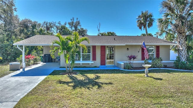 ranch-style house featuring a carport and a front lawn