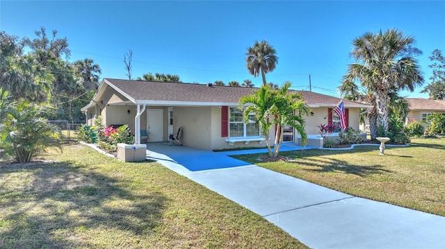 single story home with a front lawn and a carport