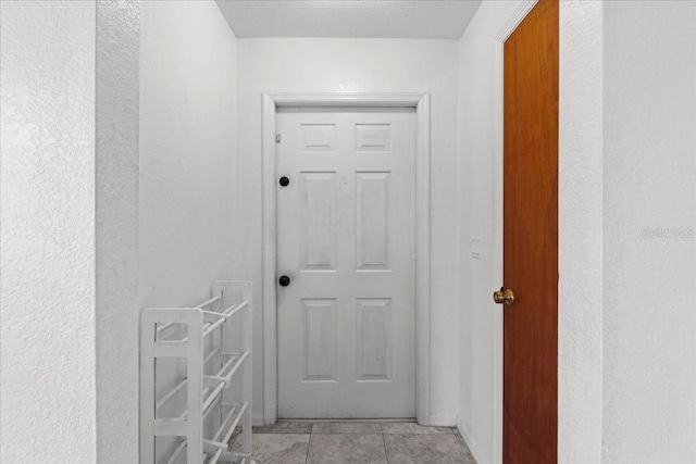 hallway with light tile patterned floors