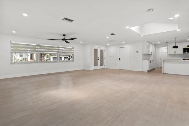 unfurnished living room with baseboards, visible vents, and recessed lighting