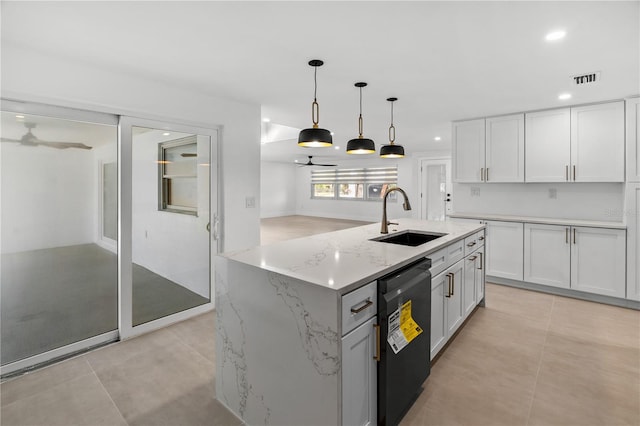 kitchen featuring black dishwasher, white cabinets, a sink, and an island with sink