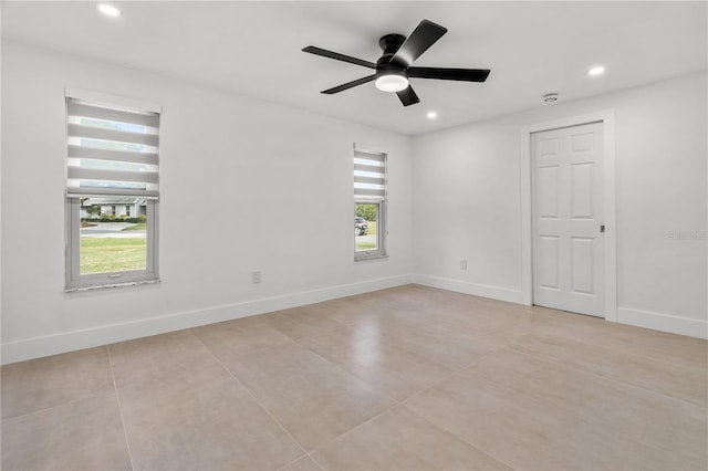 empty room with ceiling fan, recessed lighting, and baseboards