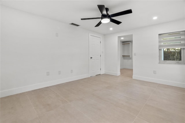 empty room featuring baseboards, visible vents, a ceiling fan, and recessed lighting