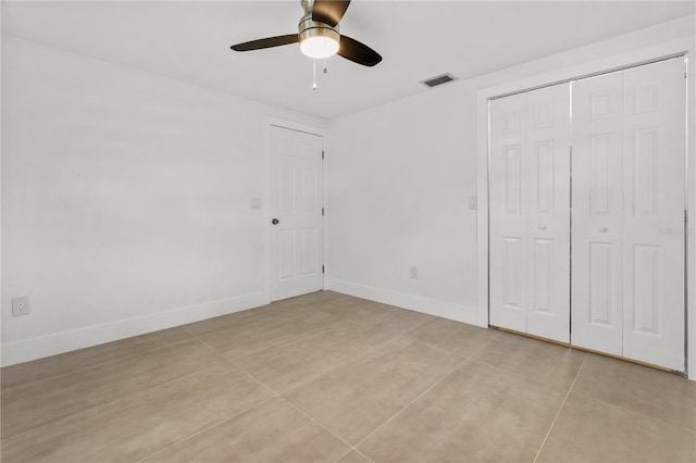 unfurnished bedroom featuring a ceiling fan, a closet, visible vents, and baseboards