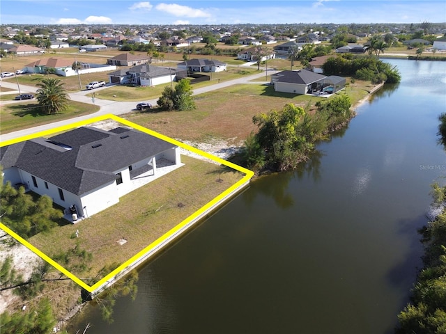 bird's eye view featuring a water view and a residential view