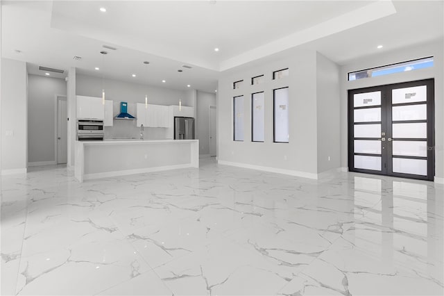 unfurnished living room with baseboards, marble finish floor, french doors, a sink, and recessed lighting