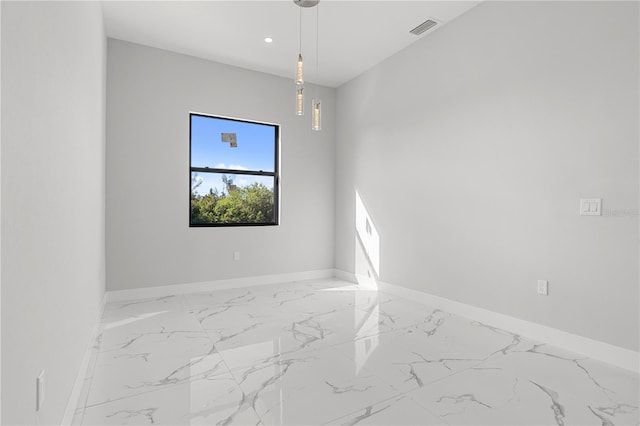 spare room featuring marble finish floor, baseboards, visible vents, and recessed lighting