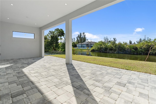 view of patio with a water view