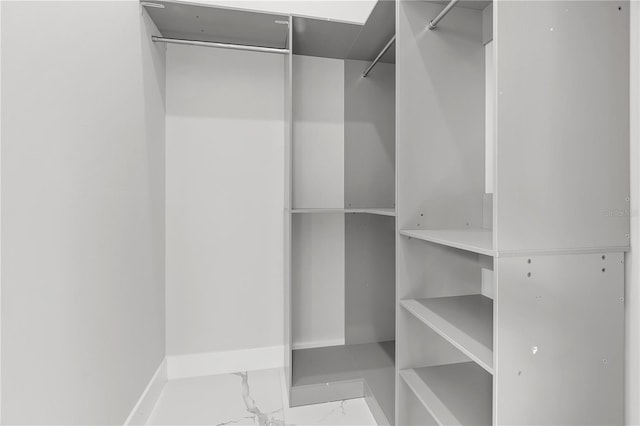 spacious closet featuring marble finish floor