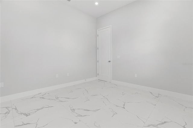 unfurnished room with baseboards and recessed lighting