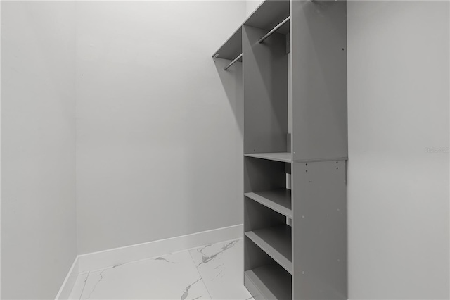 spacious closet with marble finish floor