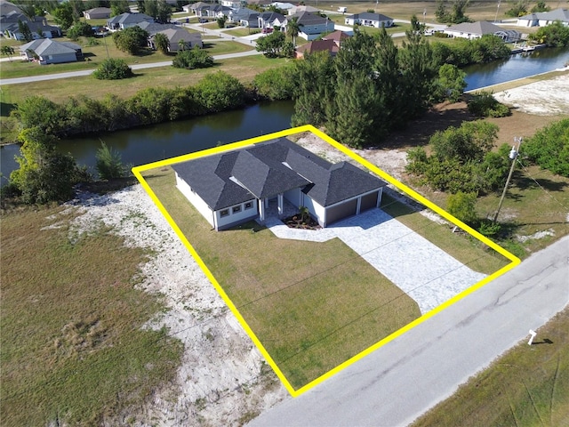 birds eye view of property with a water view and a residential view