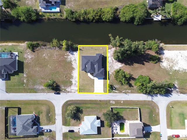 birds eye view of property with a water view and a residential view