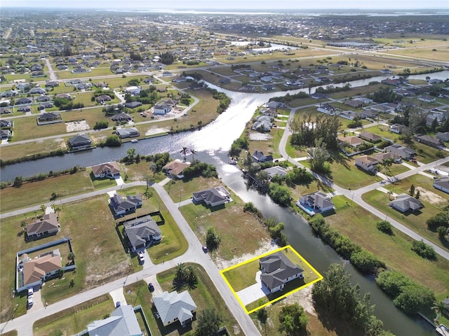 birds eye view of property featuring a water view and a residential view