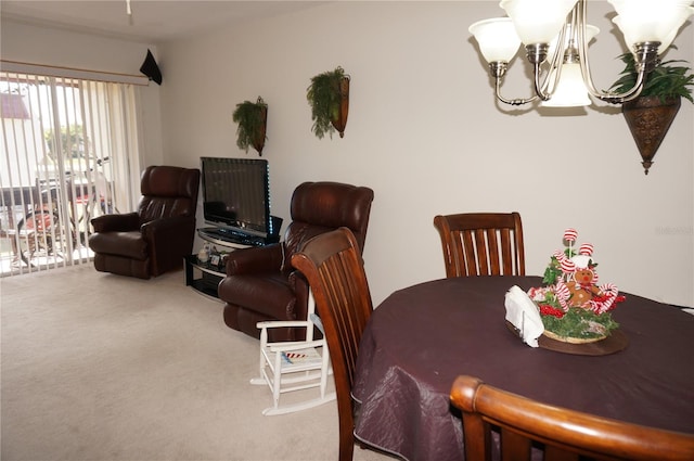 dining room featuring a chandelier and carpet