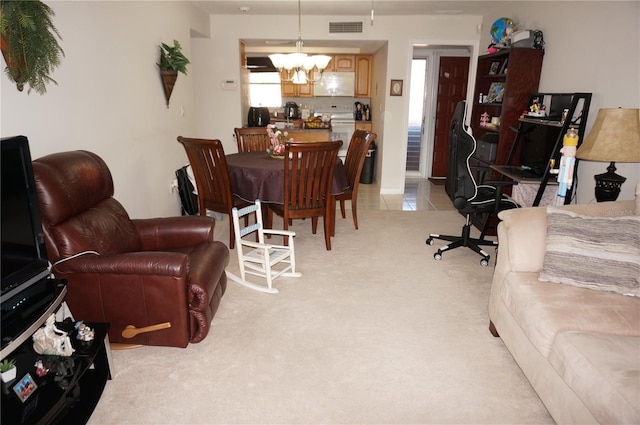 carpeted living room with a chandelier