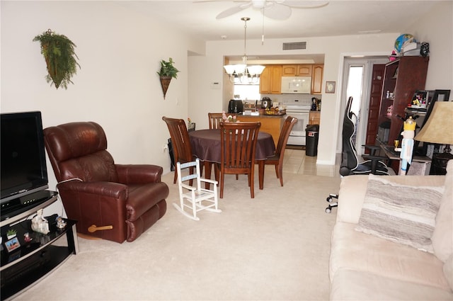 carpeted living room with ceiling fan with notable chandelier